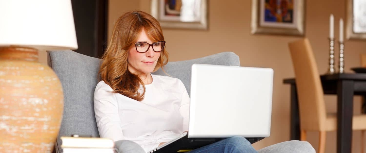 woman in living room, on her laptop